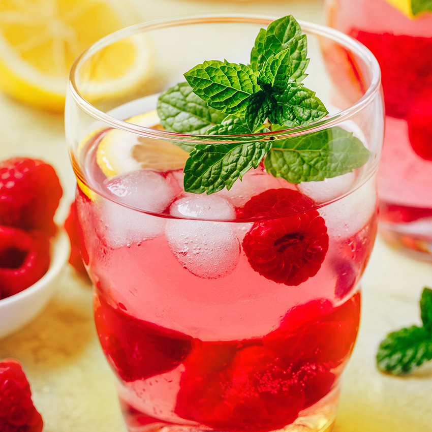 Cold drink Raspberry Lemonade with mint in glass.